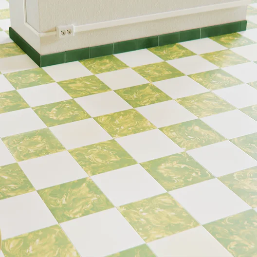 A livingroom floor with green and white cement tiles